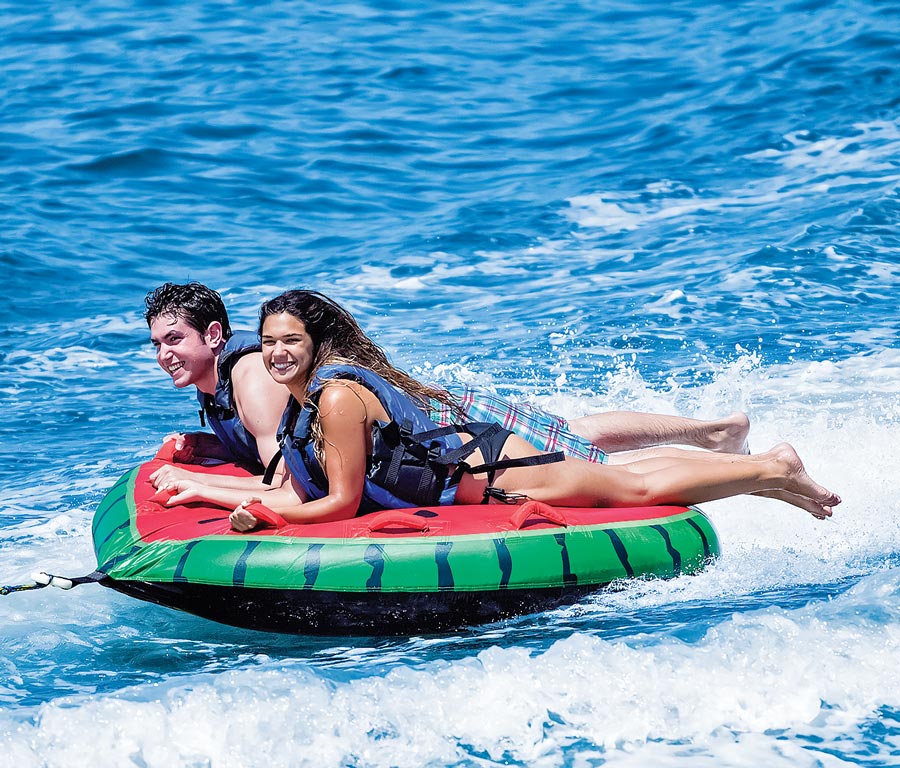 two people riding a Watermelon Island Towable