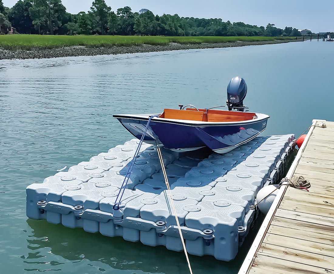 modular floating dock from Dock Blocks holding a small boat