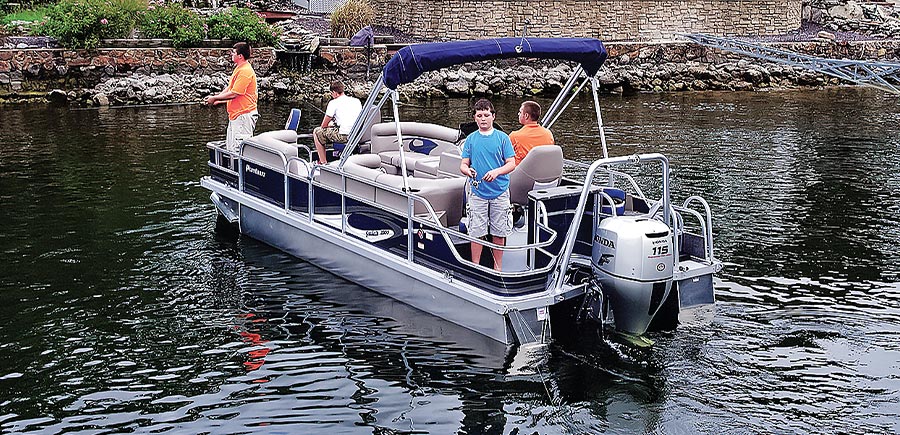 a father and sons fishing off of the PlayCraft Sunfish FX4