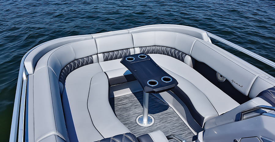 table with cupholders and couch inside boat