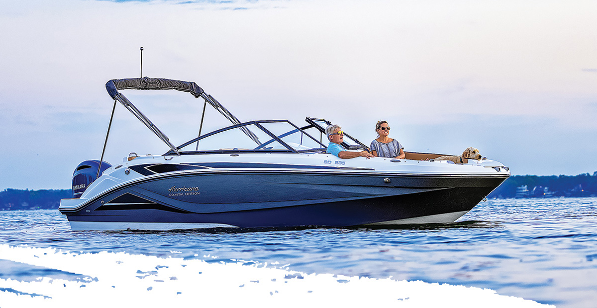 SunDeck 235-OB with Walter and his wife smiling driving