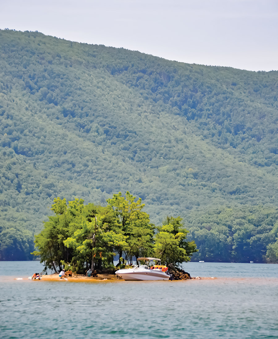 boat parked on small island in the middle of the lake