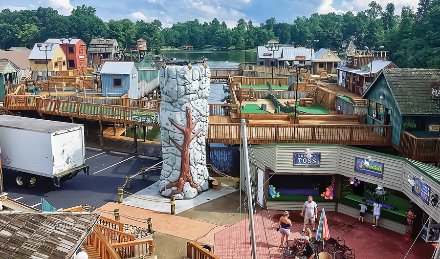 rock wall and game booths at dock of lake