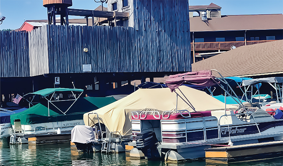 boats parked at dock with protective covers on