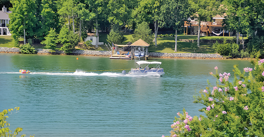 boat pulling person tubing on the lake
