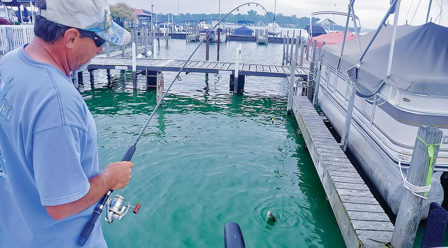 man on a pier preparing to fish