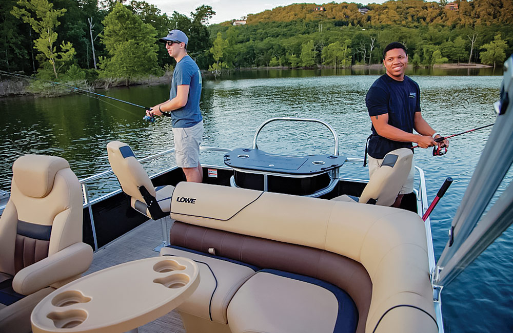 two men standing on a pontoon fishing