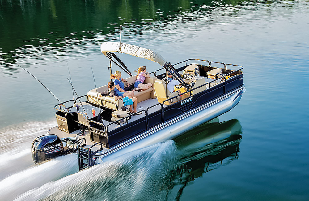 a family relaxes on their pontoon as it zips a long a body of water