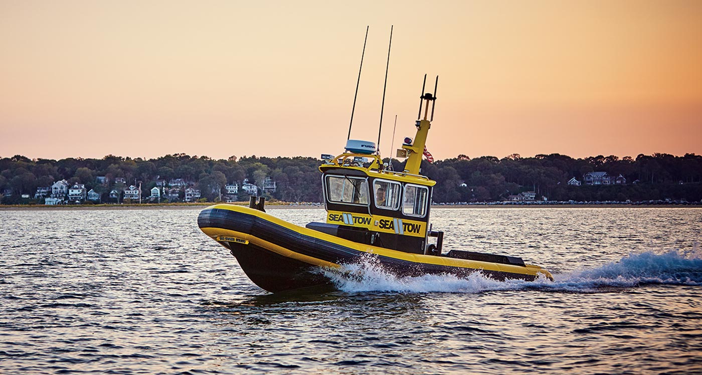a Sea Tow Services boat zooming on water
