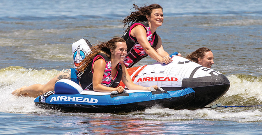 group of girls riding a Space Shuttle raft