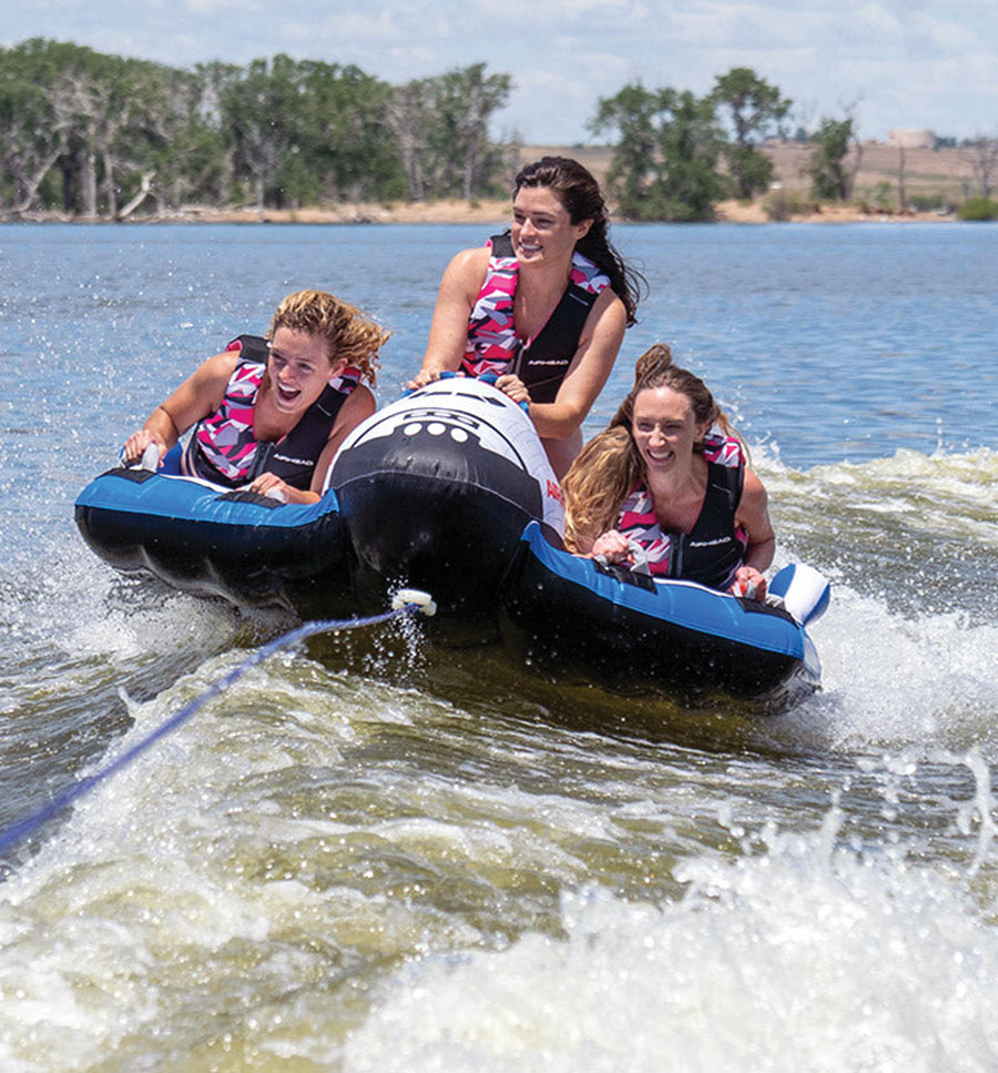 group of girls riding a Space Shuttle raft