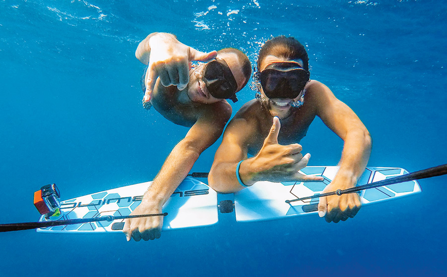 two people posing for a picture underwater using the Subwing