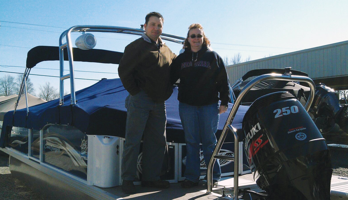 Marvin “Eddie” Edwards and his wife Laura in front of their boat