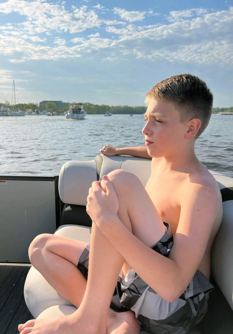 boy sitting on a boat