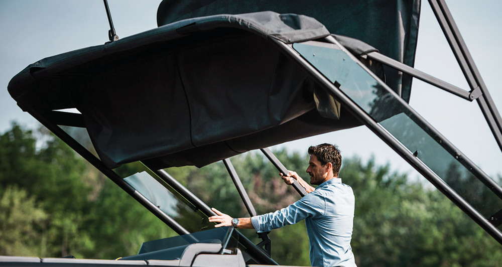 Man deploying Sport Bimini top