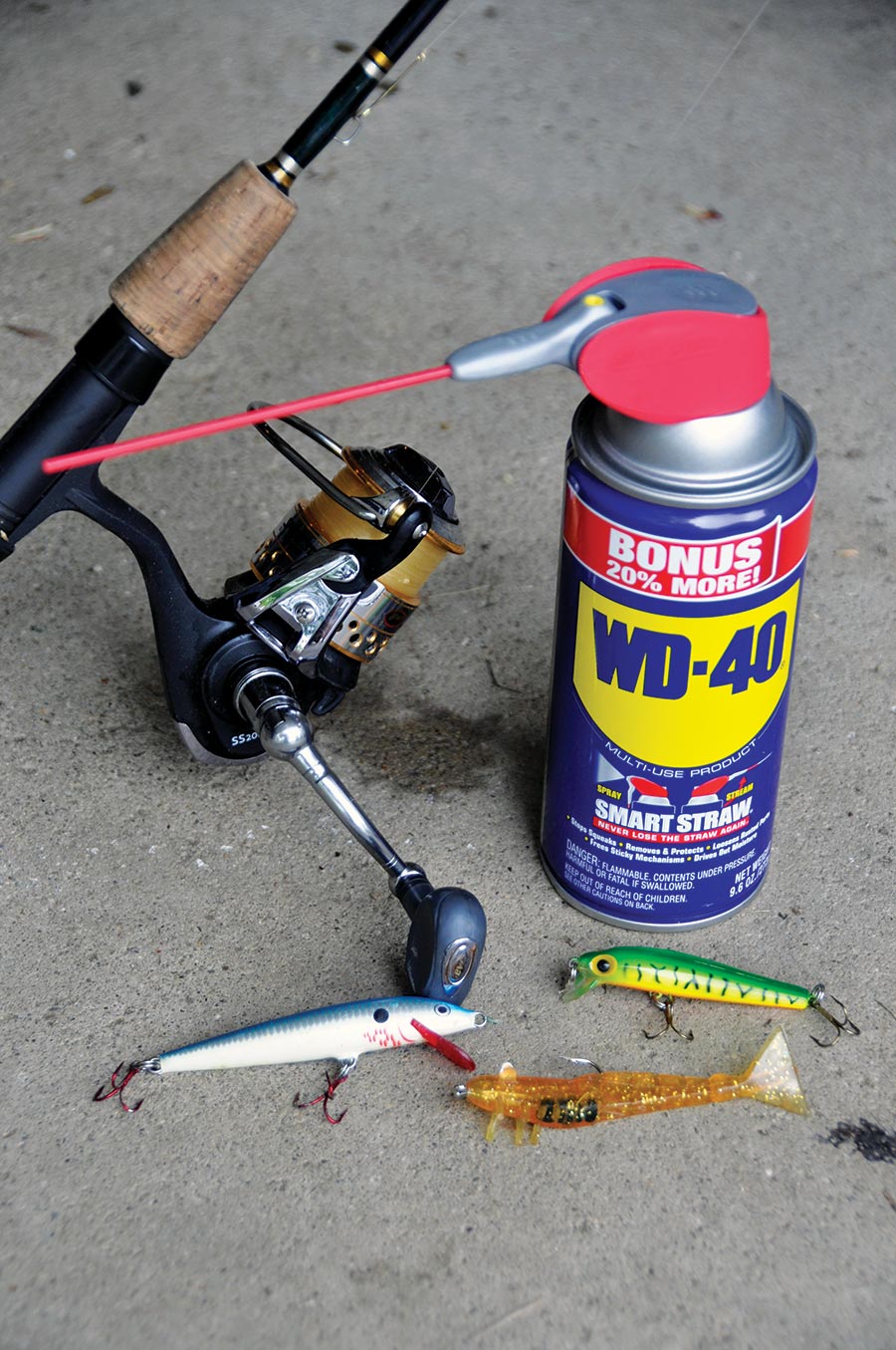 Can of WD-40 next to fishing lures and pole