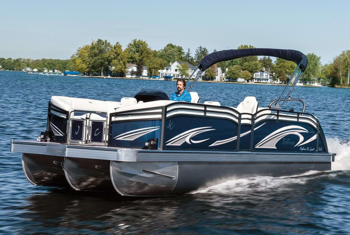 a man drives a pontoon on the water