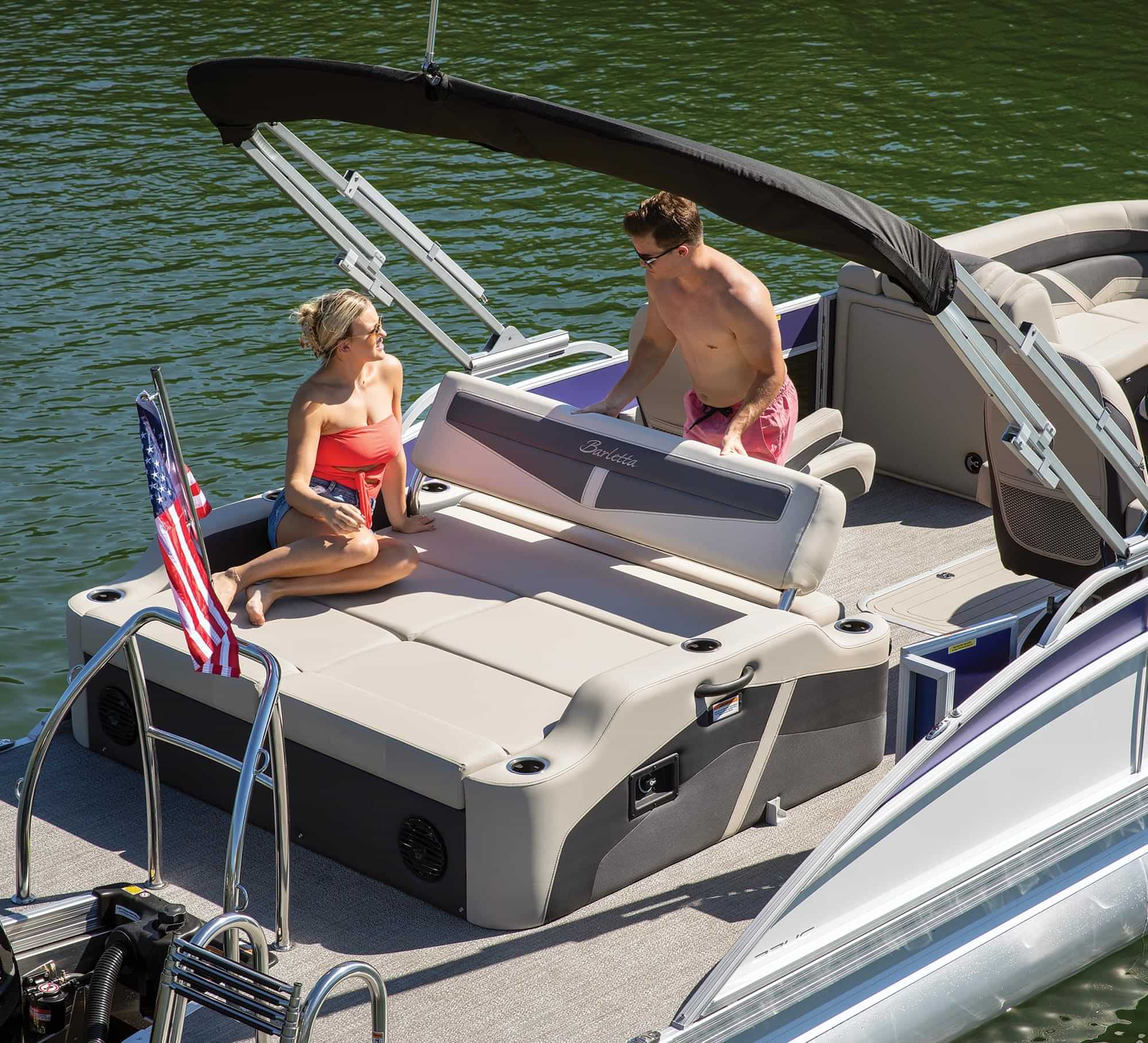 a couple relax in the passenger seating area of the Barletta Cabrio 22UC