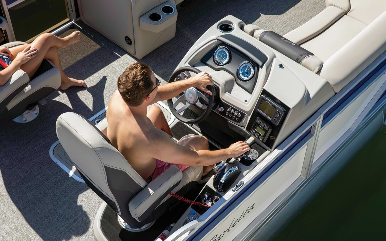 top view of a man steering the Barletta Cabrio 22UC