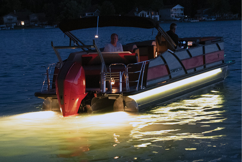 Trifecta boat with yellow underlights