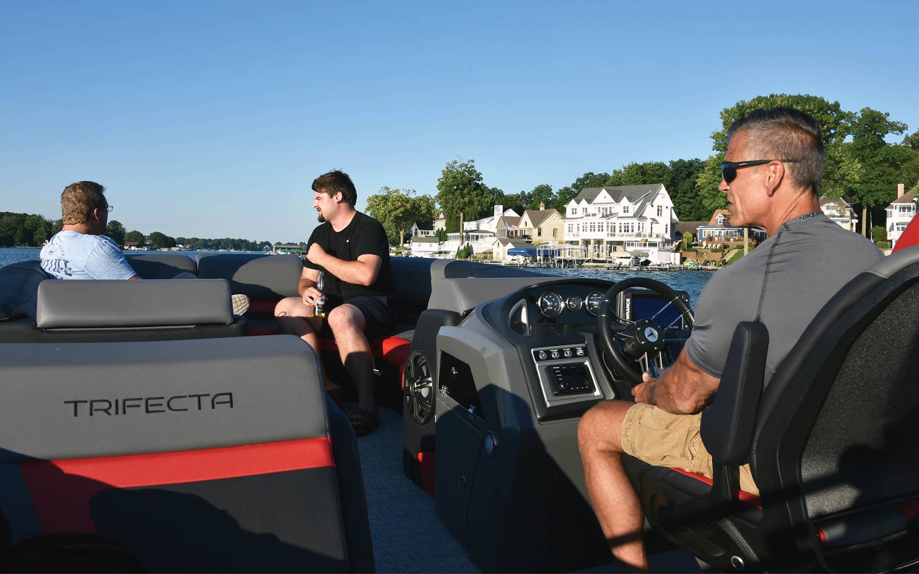 three men sitting on Trifecta boat
