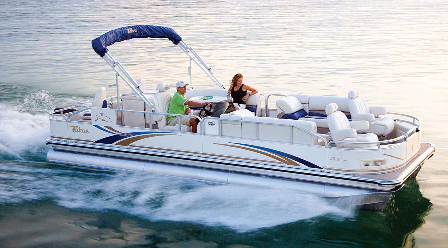 a woman relaxes on a pontoon as a man steers