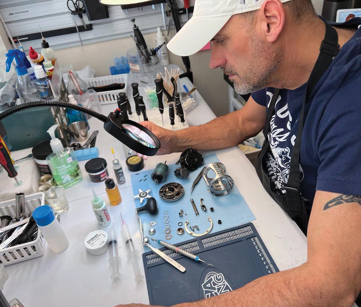 Man disassembling fishing reel.