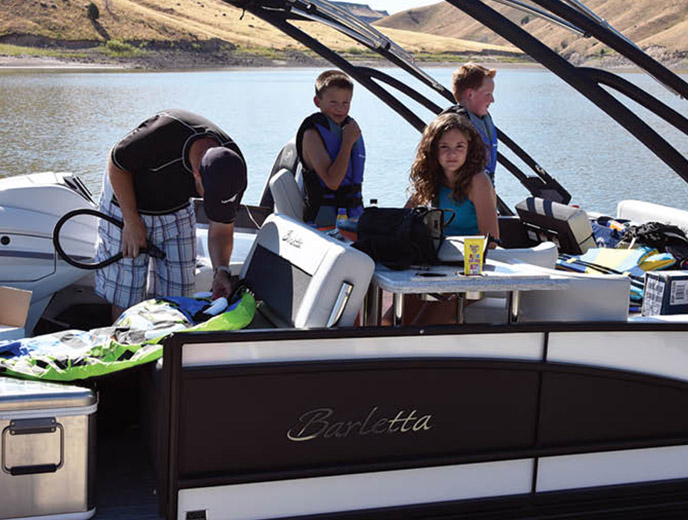 Four people in a luxurious Barletta Corsa 25UEA