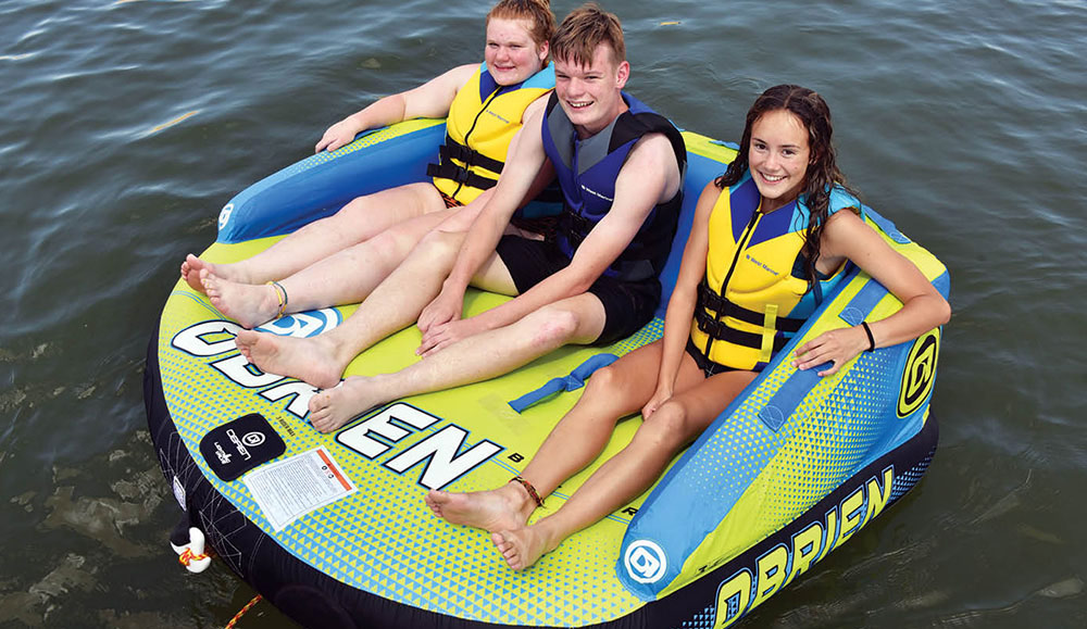 Girl riding on Airhead Shield towable