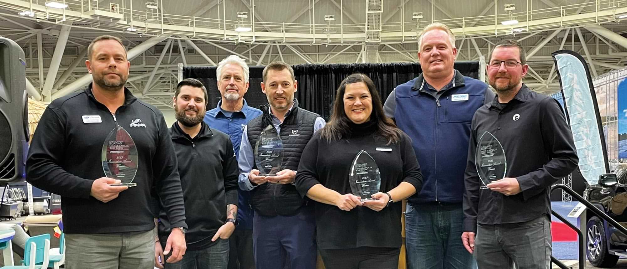award winners take a group photo with Brady L. Kay at the Minneapolis Boat Show
