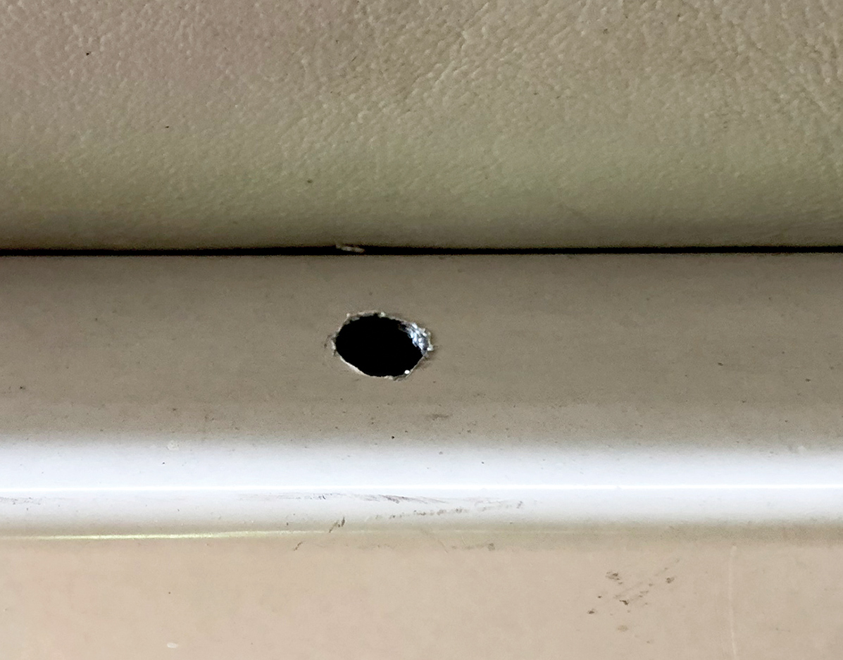 Close-up view of a drilled 1/8-inch hole at the fence rail center area site of the Starcraft Marine Classic 180 boat