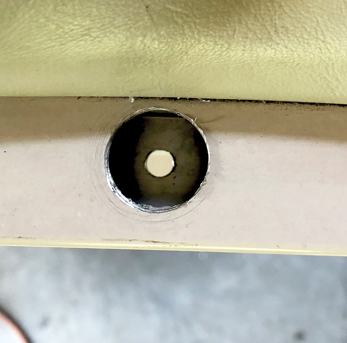 Top close-up view of a drilled 1/4-inch hole at the fence rail center area site of the Starcraft Marine Classic 180 boat