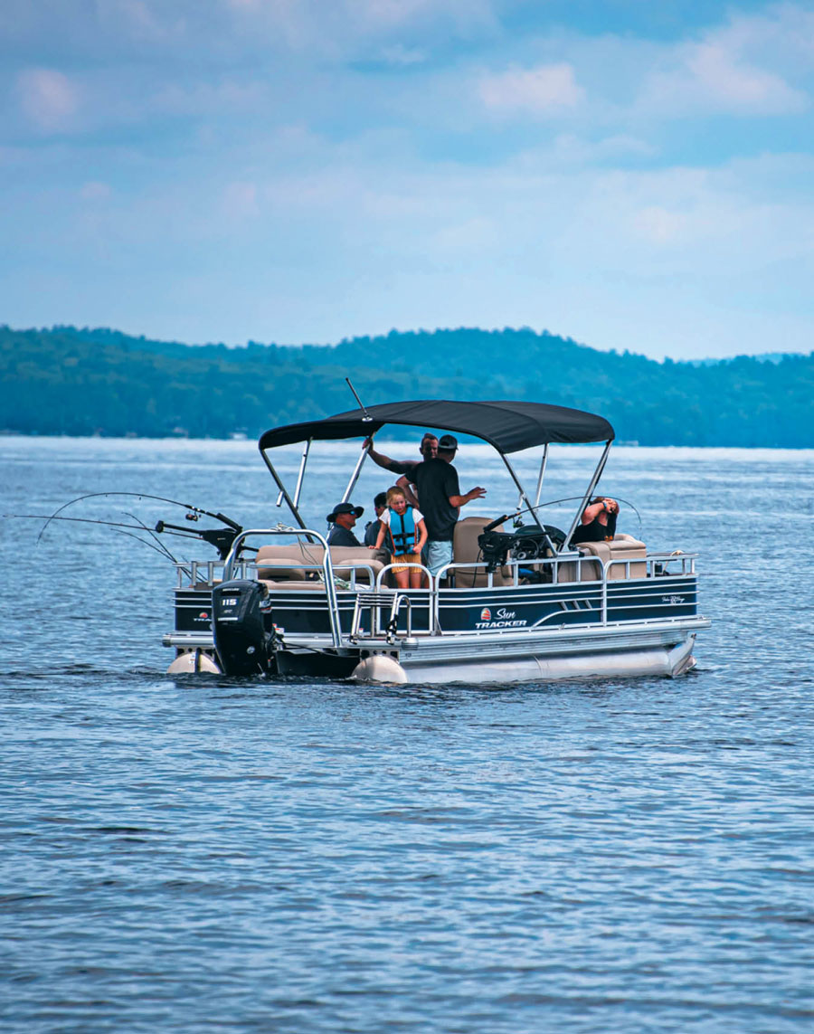 family together on a pontoon boat on the water