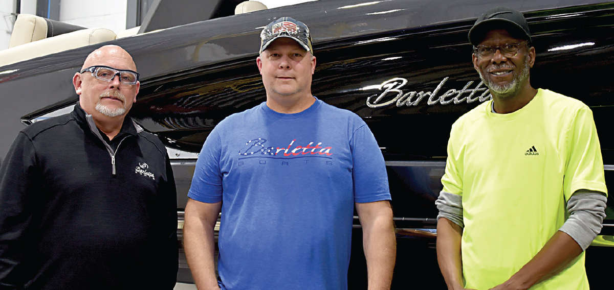 three men smiling side by side