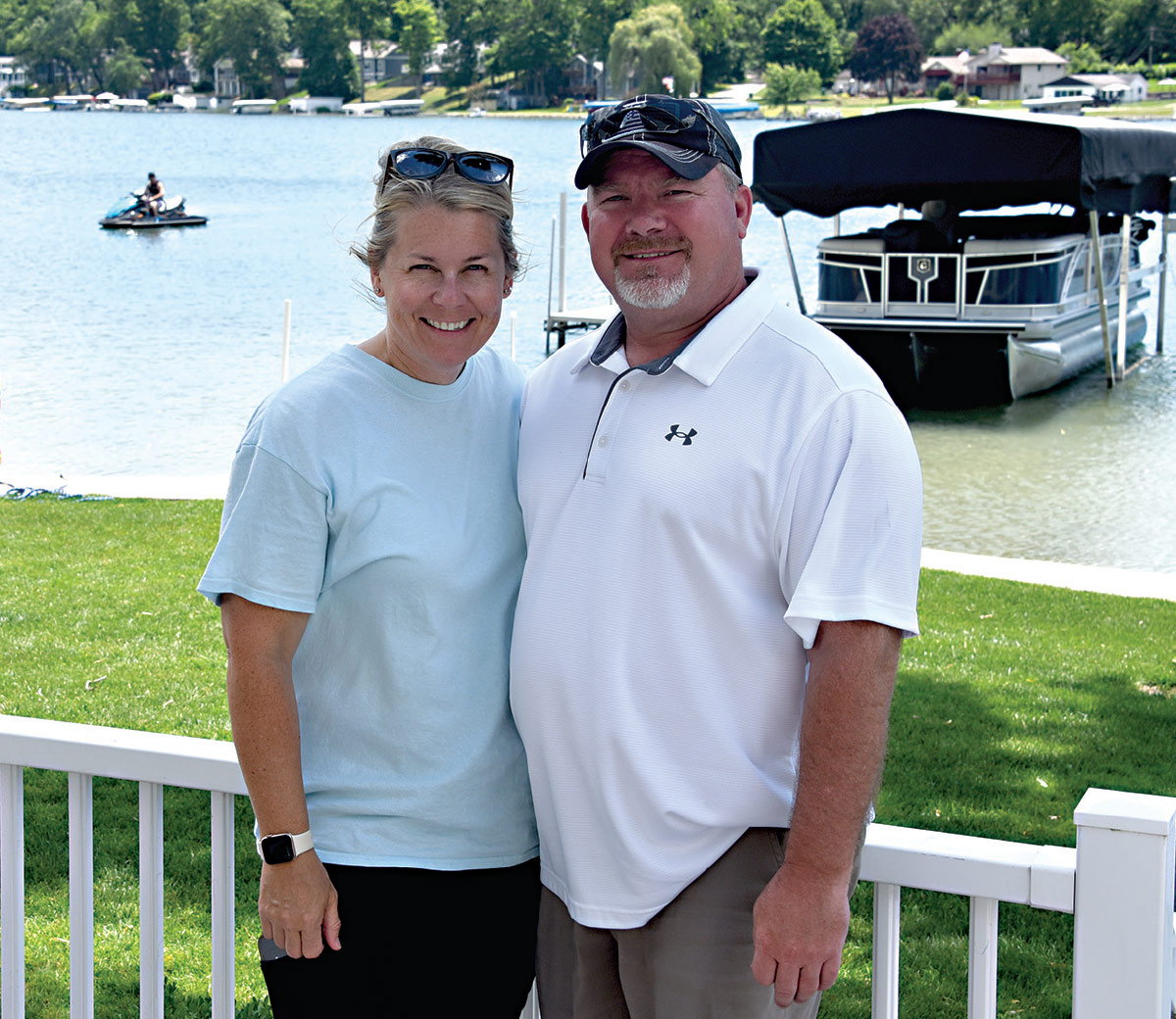 Steve and his daughter smiling near water and boat