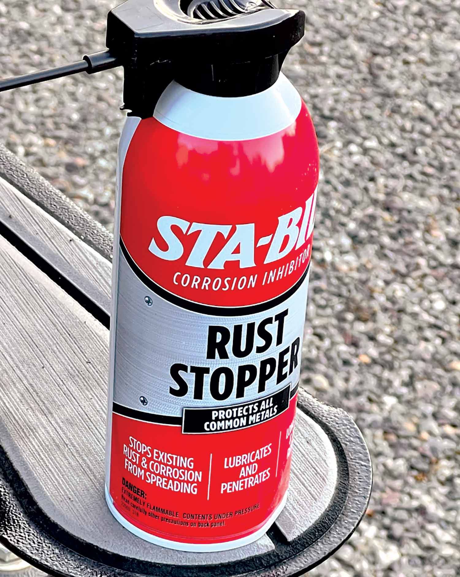 Close-up photograph perspective of STA-BIL's Rust Stopper aerosol protectant on top of a boat trailer hitch area