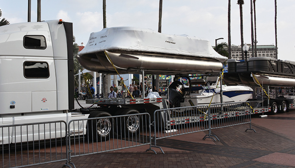 pontoon boat being lifted from truck