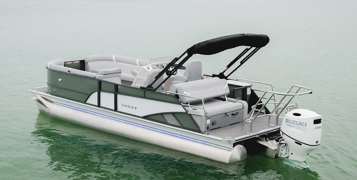 A white and grey Crest pontoon sitting on the water.