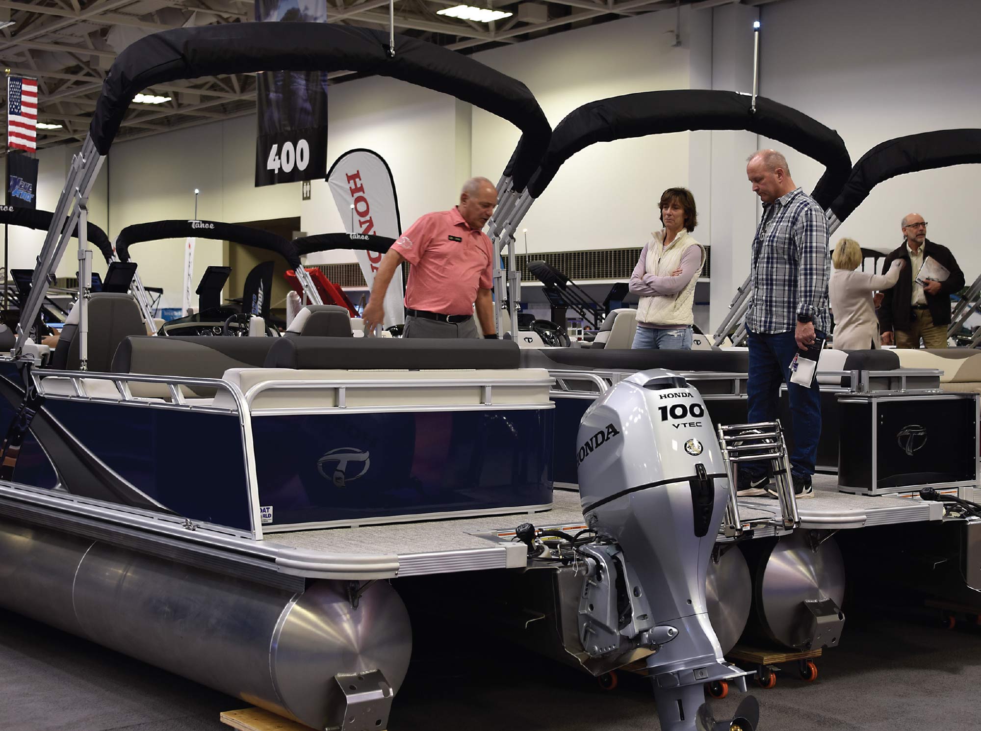 two men and a woman on boat in show room