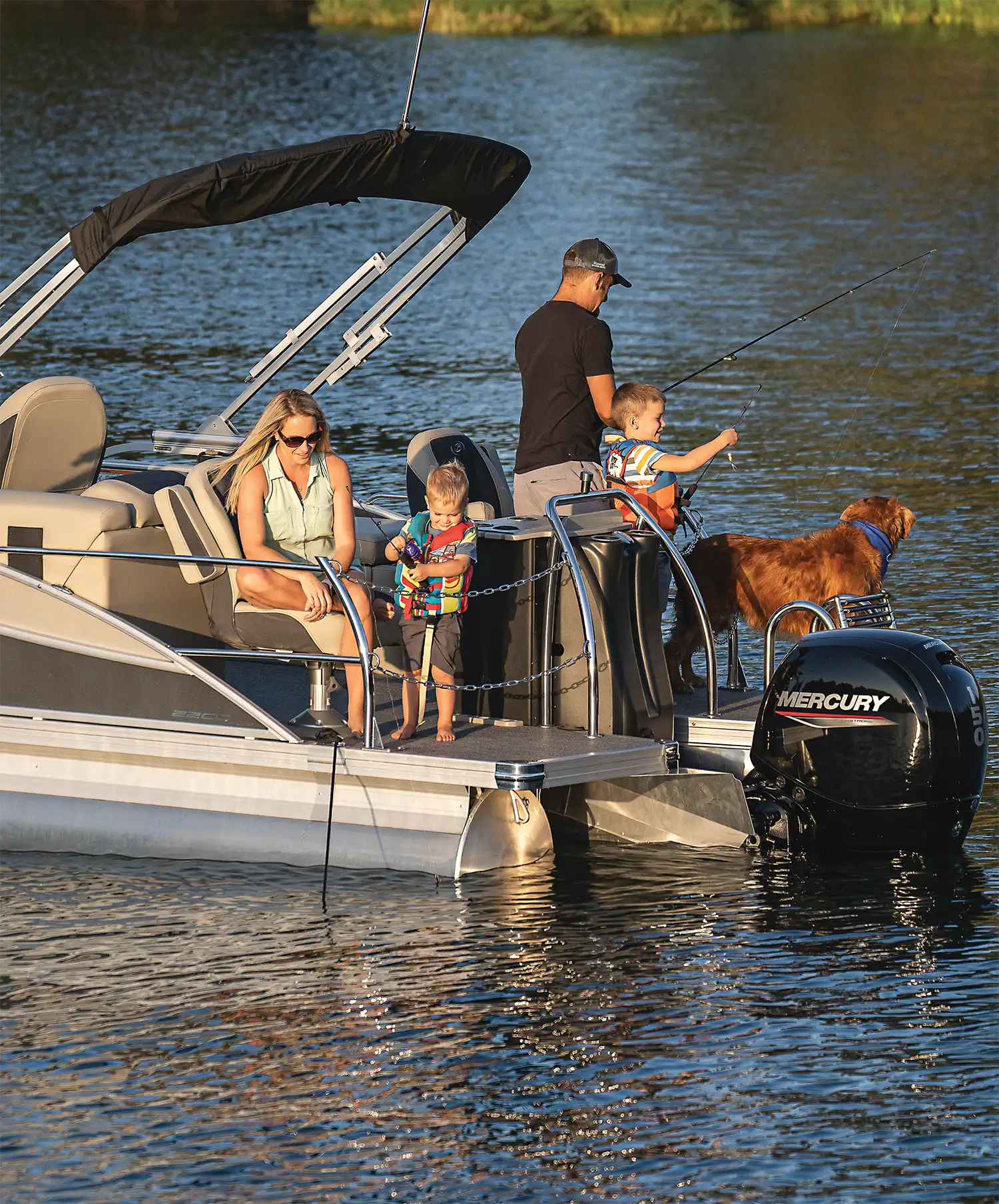 family on a pontoon boat with their dog