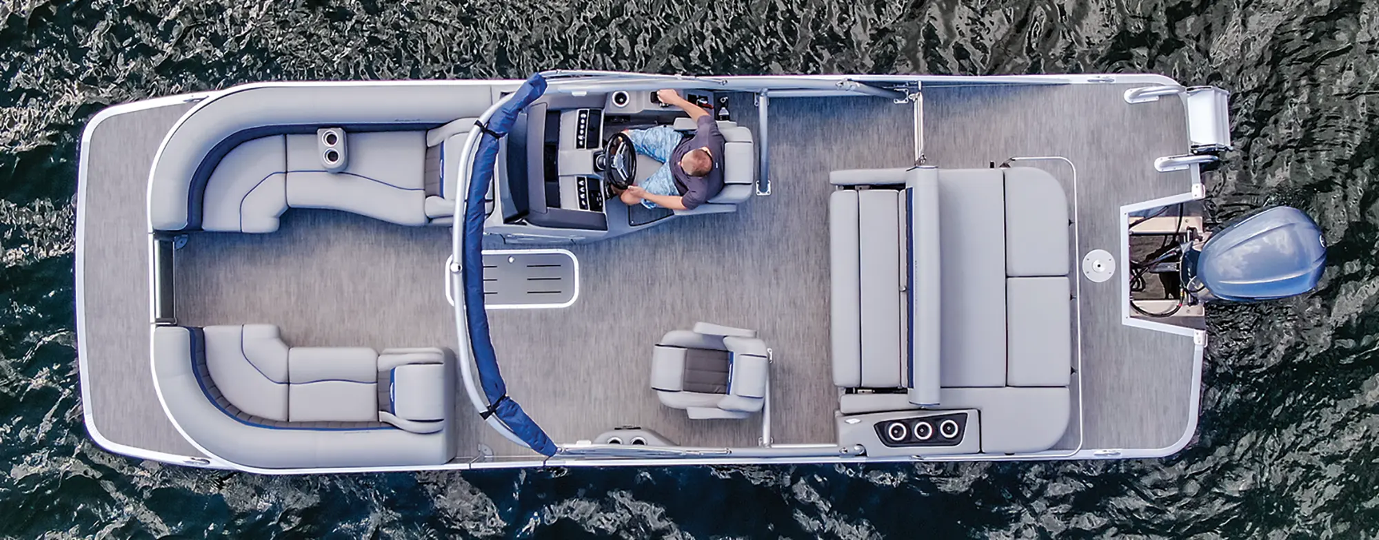 Aerial view of the Bennington Sport 24 LXSSBA pontoon motorboat vehicle as a man is seen driving out in the water during the day
