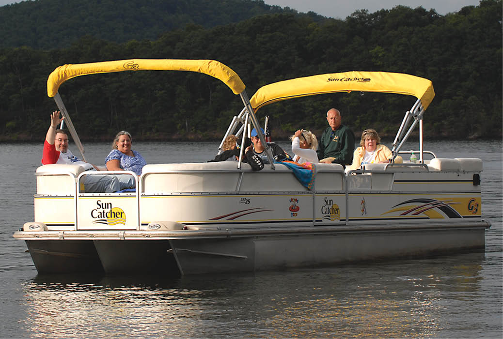 family enjoying their pontoon out on the water