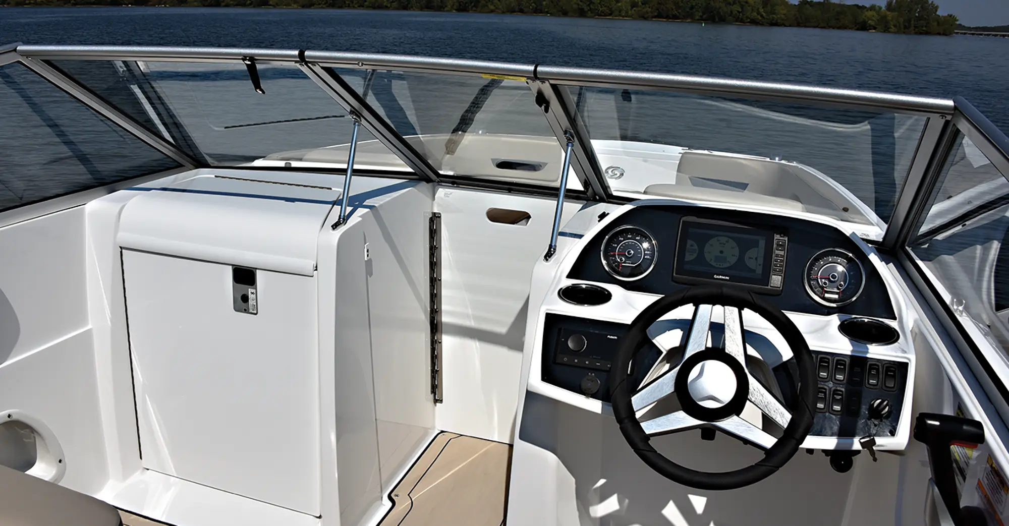 Aerial interior angle photo view of the driver's side and storage space area nearby of the Hurricane SunDeck 235 pontoon motorboat vehicle