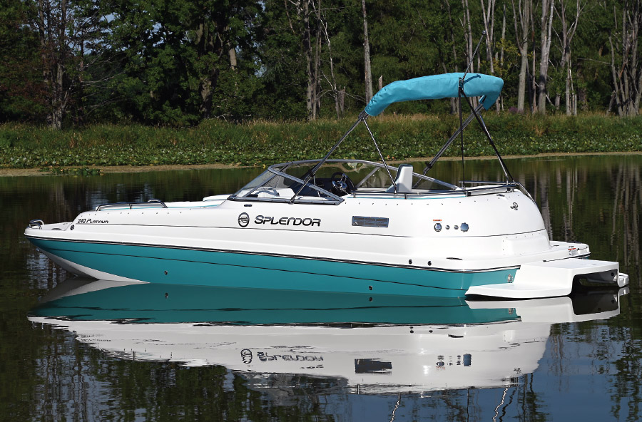 side profile of teal and white Splendor boat in water