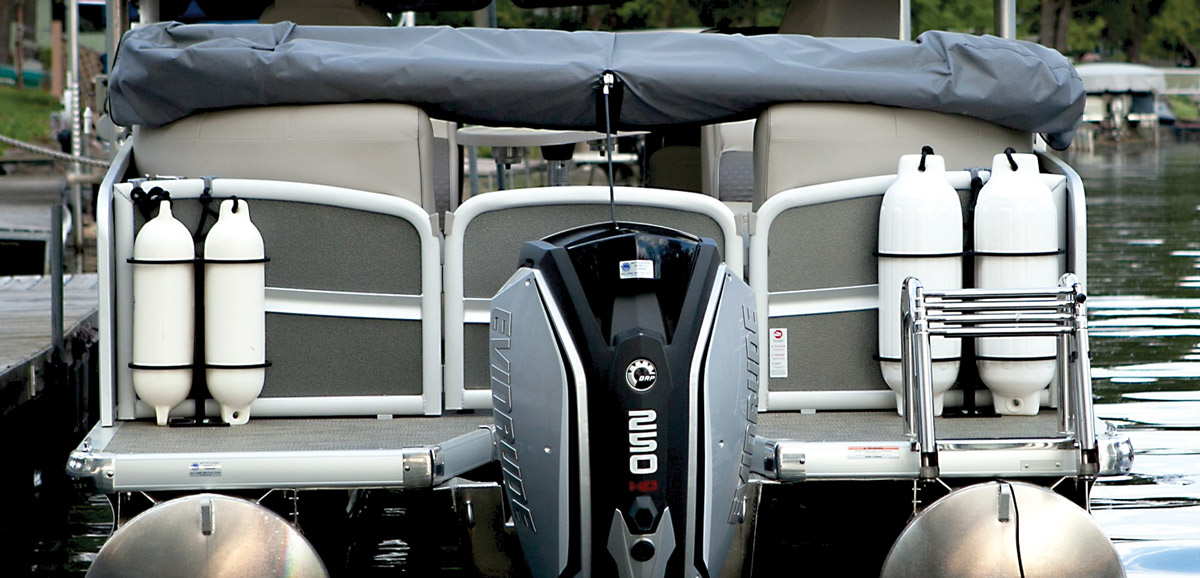 the stern of a pontoon with a focus on two sets of different sized bumpers attached just outside the stern gate
