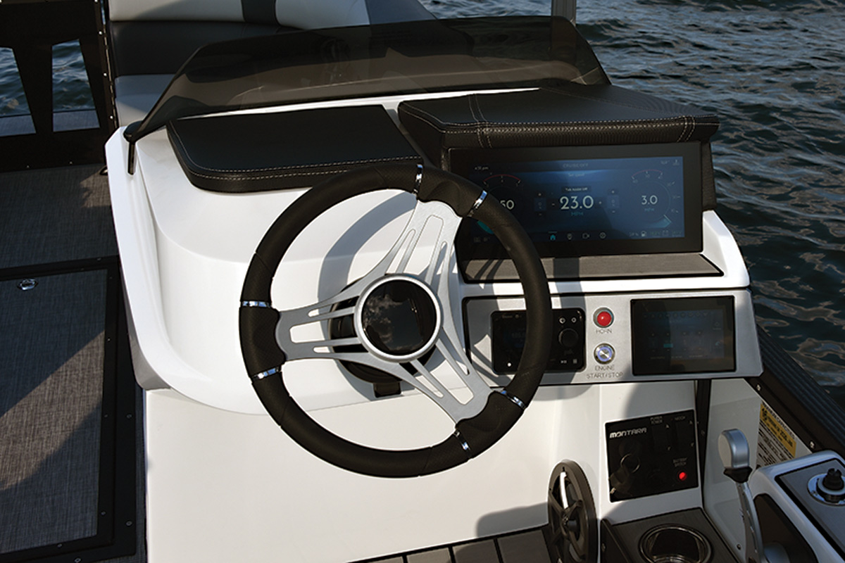 Close-up of steering wheel and touch screen in driver's area of Montara Boats Surf Boss 25