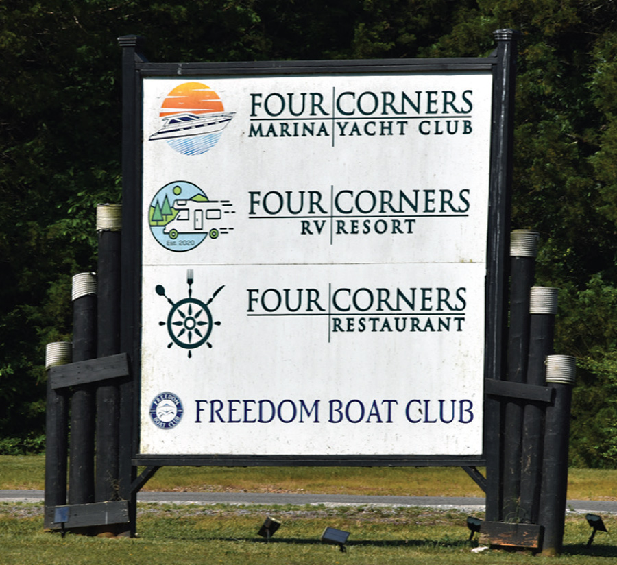 road sign with all four corners club logos