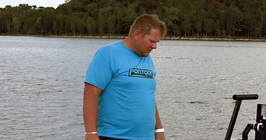 Jason Huff in blue Pontoon shirt on boat