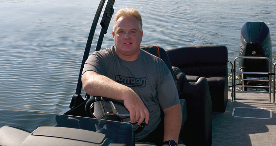 Brady Kay sitting in driver's seat in gray Pontoon shirt