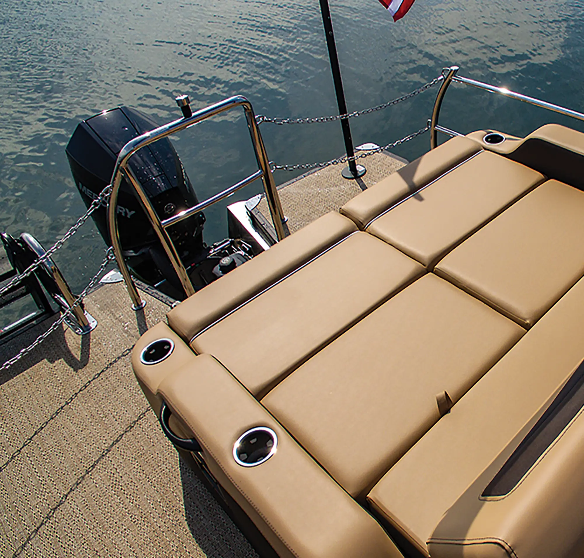 Landscape close-up angle photograph view of the Mercury 200 V6 Outboard engine equipped onto the Barletta Cabrio C22UC pontoon motorboat vehicle and a passenger lounge couch with cupholders